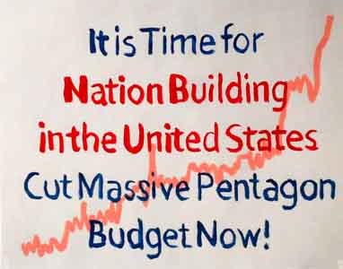 Protest sign against  Pentagon Budget by Tom Lohre.
